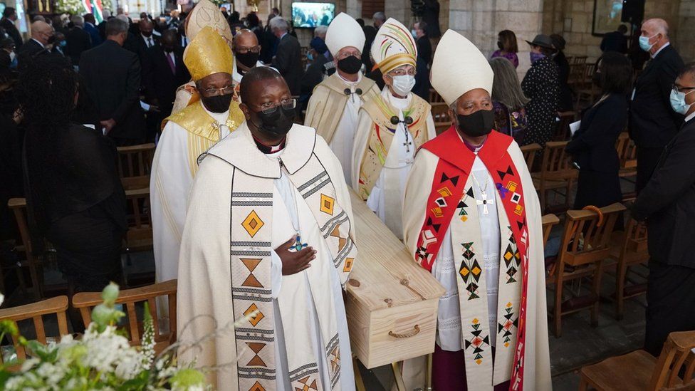 Members of the clergy carry the coffin of the late Archbishop Emeritus Desmond Tutu as they exit the St. Georges Cathedral during his state funeral in Cape Town, South Africa, 01 January 2022.