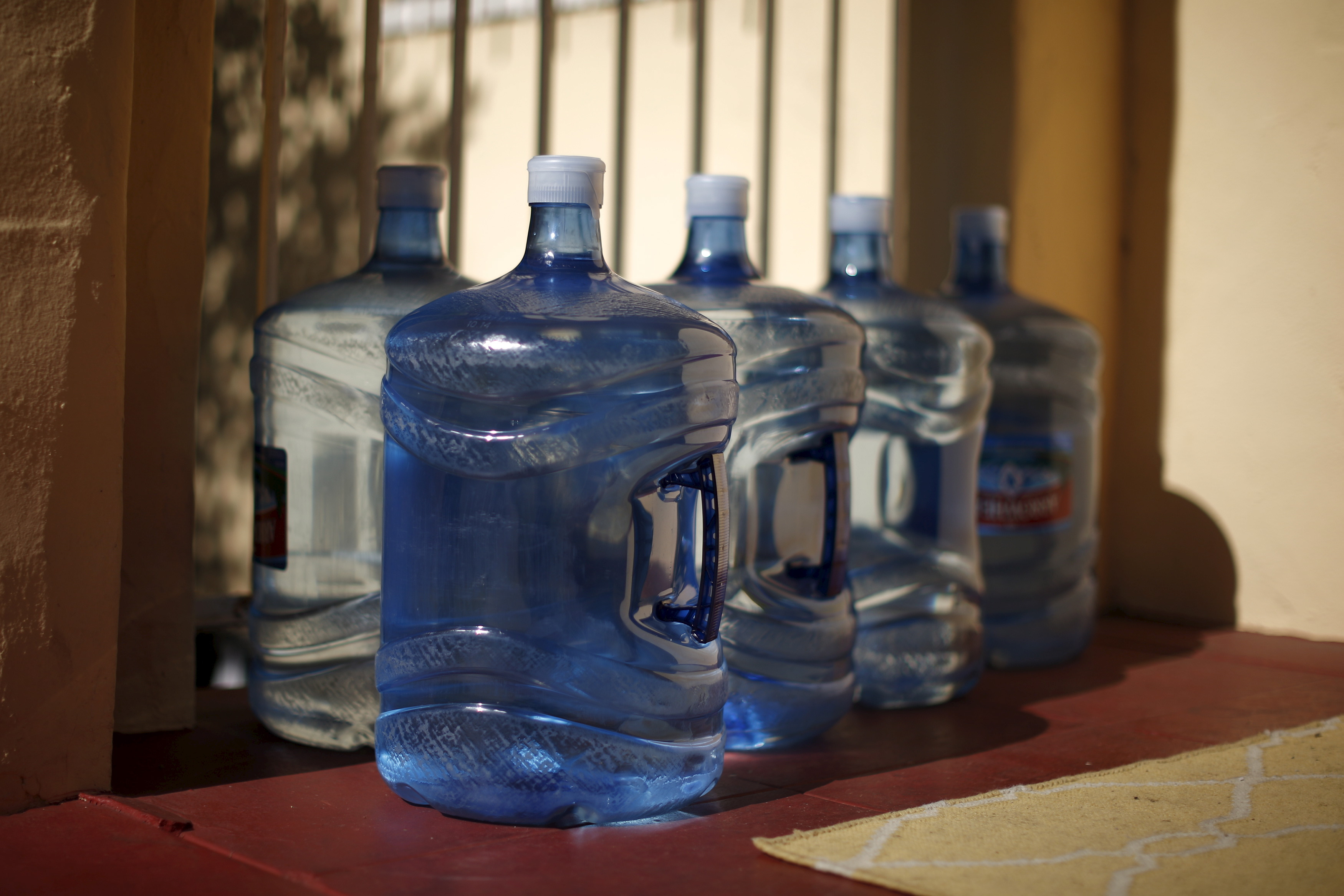 Containers full of drinking water sit on the doorstep after being delivered to a home in Los Angeles