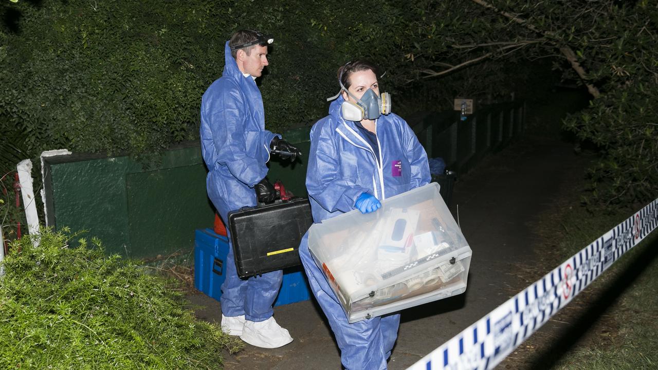 Police and forensics officers remove items after the mummified body of Shane Snellman was found with a shotgun wound to his neck. Picture: Dylan Robinson