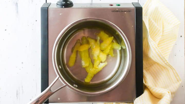 Lemon simple syrup in a small stainless steel pot.