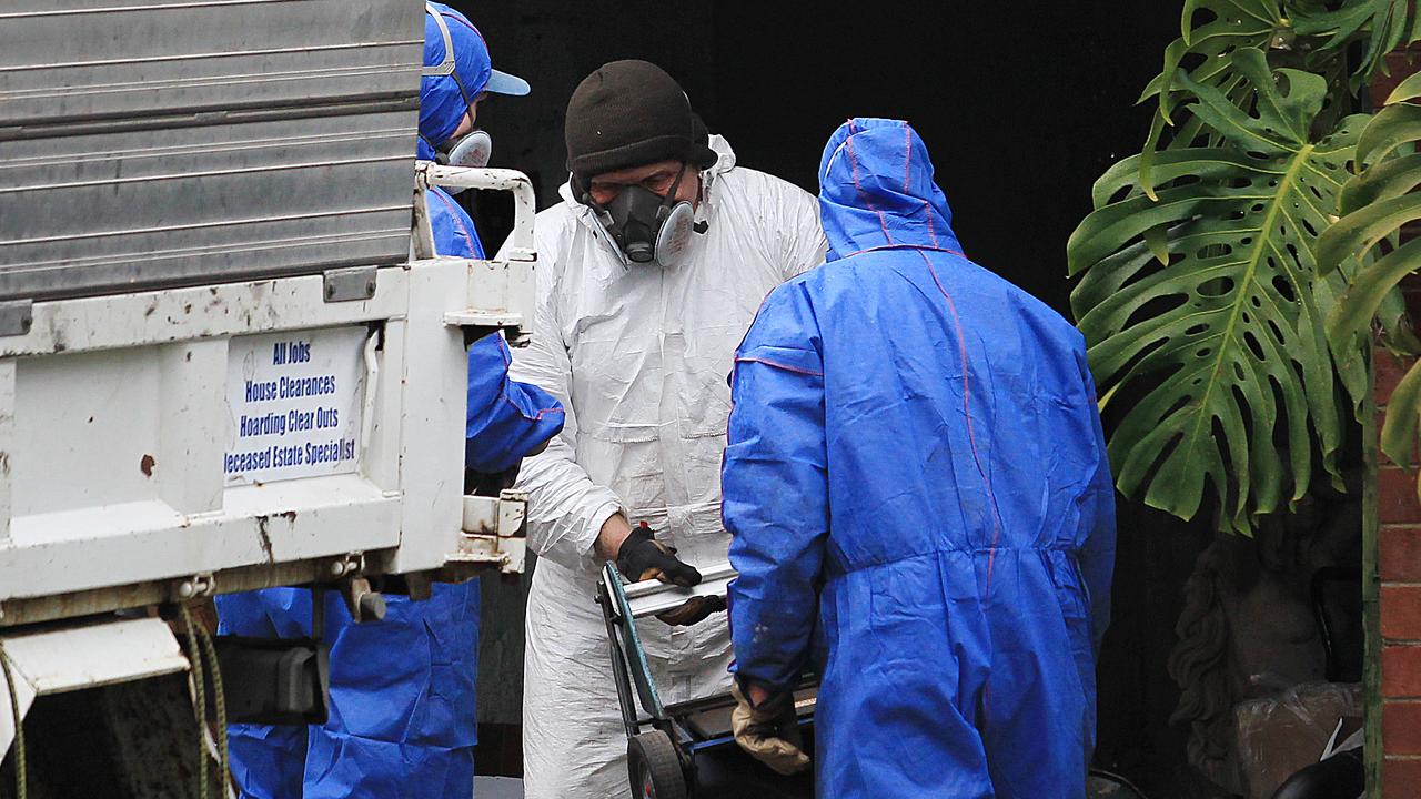 Forensic police clear the house where the decomposing bodies of two dead men were found within a year of each other.