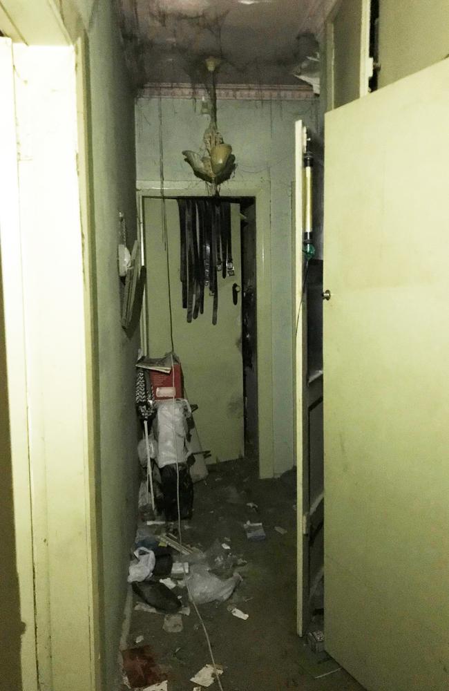 A hallway in the death house where police made their way through walls of debris to discover a recently deceased Bruce Roberts’s badly charred body slumped over a heater.