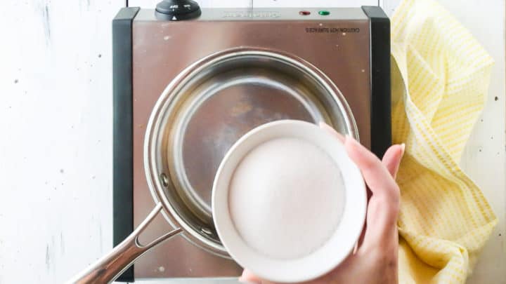Placing sugar in a small pot.